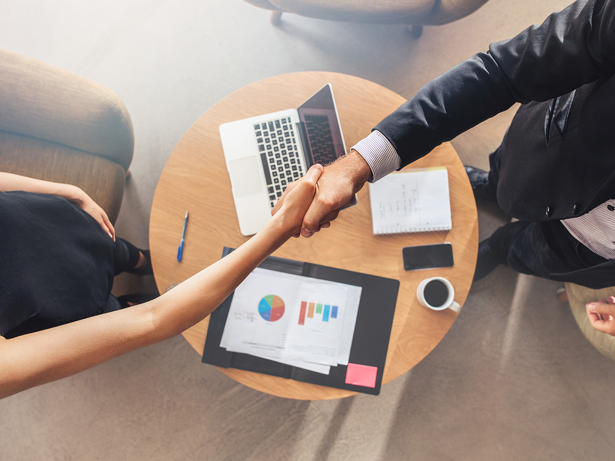 A business owner and their accountant shaking hands