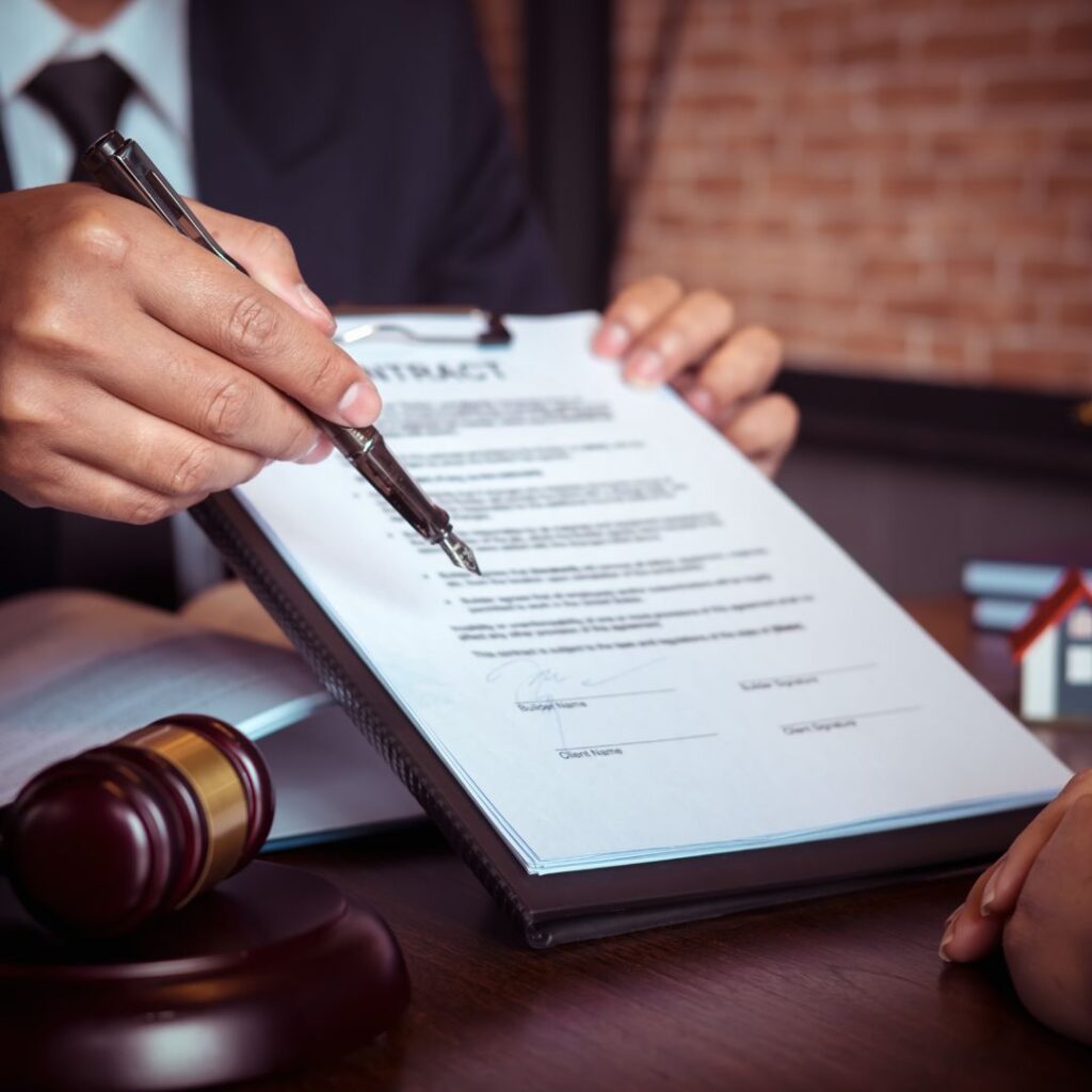 man pointing to line where client needs to sign a document